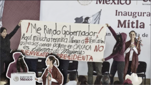 Con una manta que decía “En Oaxaca no es tiempo de mujeres”, María Elena Ríos tomó el micrófono en un evento oficial para señalar la impunidad en su caso.